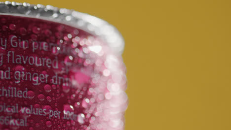 Close-Up-Of-Condensation-Droplets-On-Revolving-Takeaway-Can-Of-Cold-Beer-Or-Soft-Drink-Against-Yellow-Background-With-Copy-Space-3